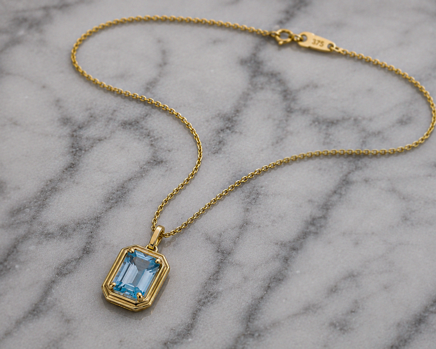 Elongated Aquamarine Pendant in 9ct Gold Curb Chain