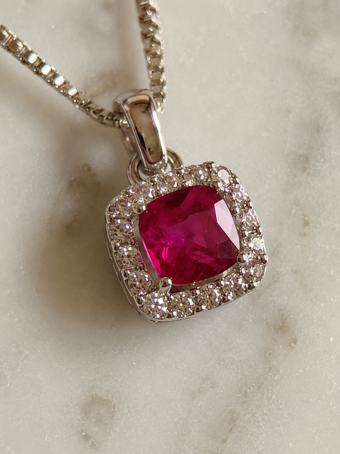 Cushion Cut Ruby & Diamond Halo Pendant Necklace in 9ct White Gold
